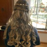 tight romantic curls in half up half down look with 6 braids and hairpiece