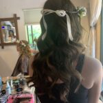 bow and flower accent for half up half down wedding hairstyle
